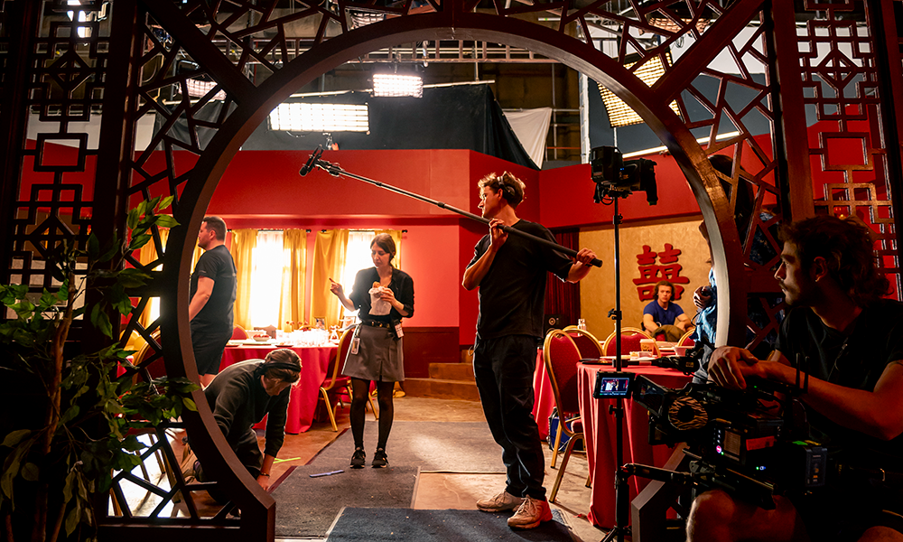film set inside chinese restaurant with crew
